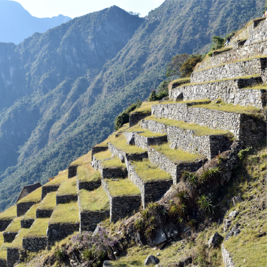 Hikers walking the Inca Trail surrounded by mountains